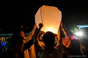 Friends brace together to fly a lantern celebrating with Aron and Sharon!